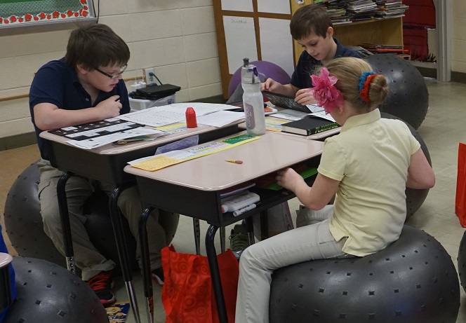 students with exercise ball chairs